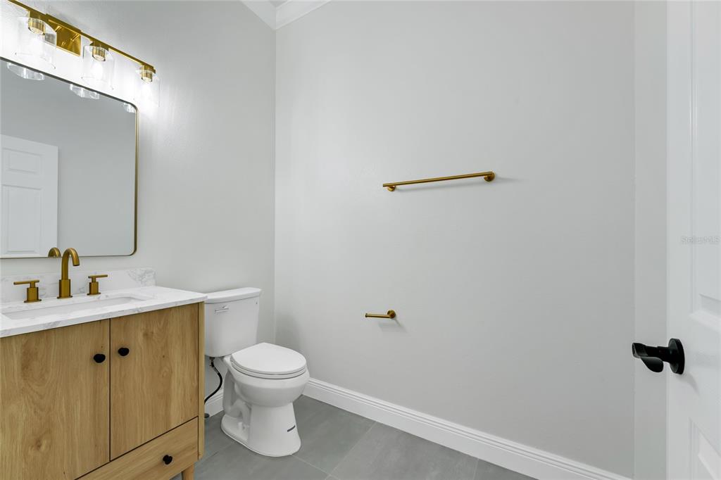 1703 Roberts Landing Road Windermere, FL 34786 - Photo 22 of 61 a bathroom with a toilet a sink and mirror