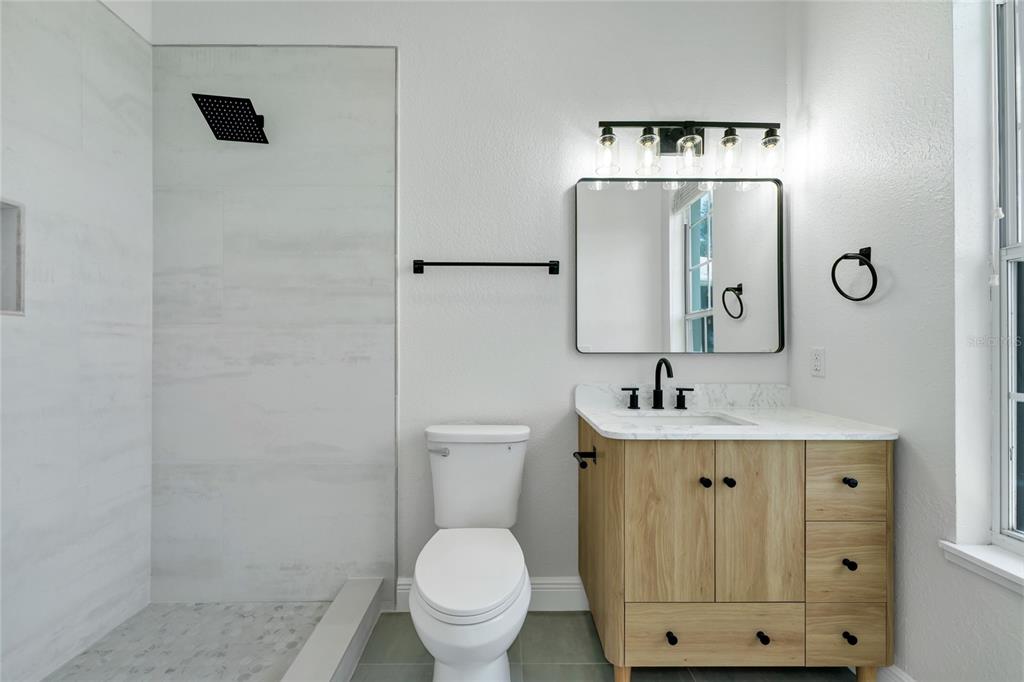 1703 Roberts Landing Road Windermere, FL 34786 - Photo 32 of 61 a bathroom with a toilet a sink and a mirror