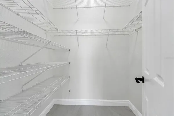 a bathroom with a double vanity sink and mirror with toilet