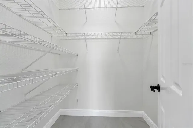 a bathroom with a double vanity sink and mirror with toilet