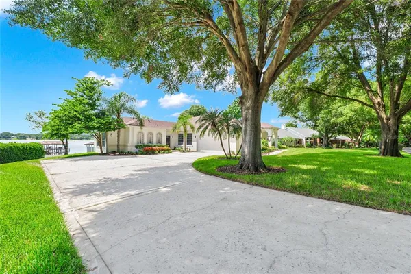 an aerial view of a house a yard and lake view