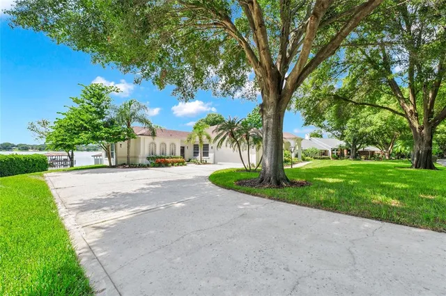 an aerial view of a house a yard and lake view