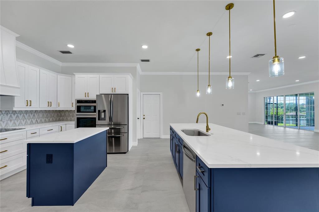 1703 Roberts Landing Road Windermere, FL 34786 - Photo 6 of 61 a kitchen with stainless steel appliances kitchen island a sink a stove a refrigerator a center island and a window