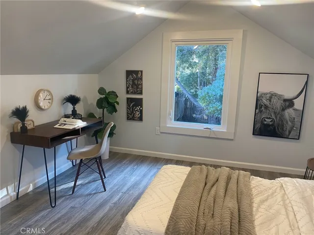 a view of a workspace with furniture and a window