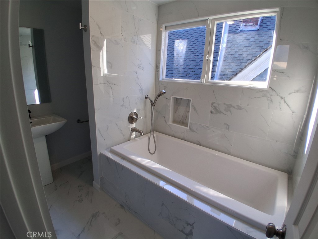 3520 Harrison Street Oakland, CA 94611 - Photo 13 of 24 a bath tub sitting next to a white sink