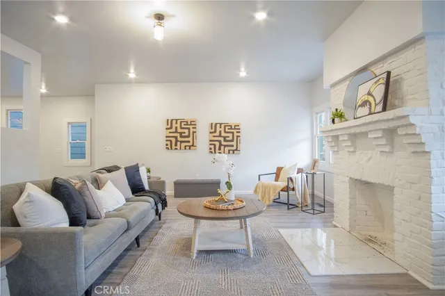 a bedroom with a bed and a wooden floor