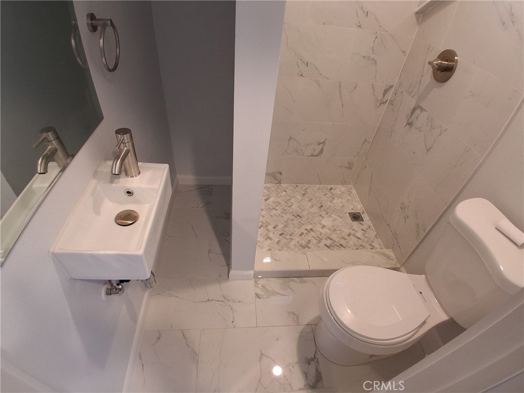 3520 Harrison Street Oakland, CA 94611 - Photo 17 of 24 a white toilet sitting next to a bathroom sink