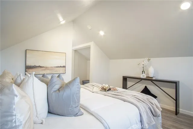 a view of a backyard with large trees and wooden fence