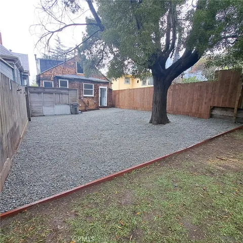 a view of backyard with wooden fence
