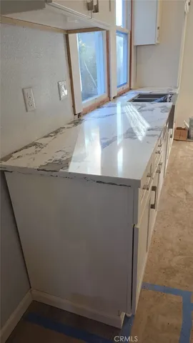 a view of a kitchen from a hallway