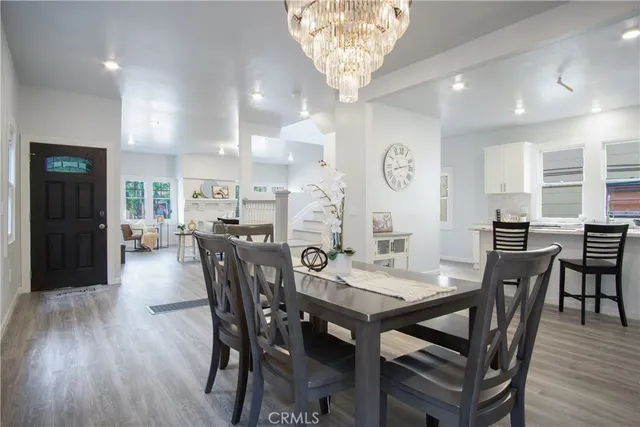 a kitchen with a table chairs refrigerator and cabinets