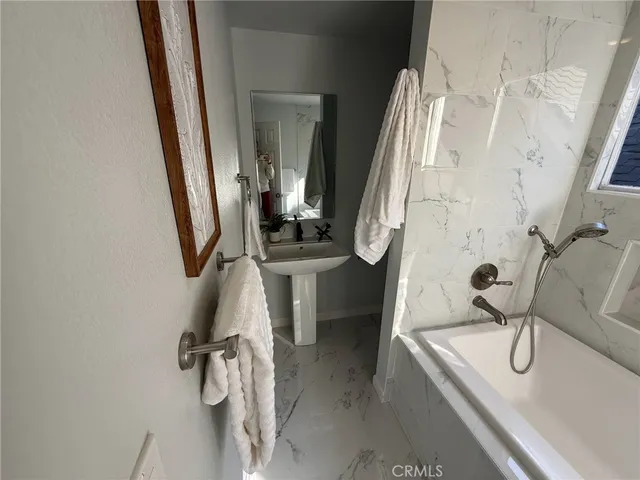 a bathroom with a sink a mirror and shower
