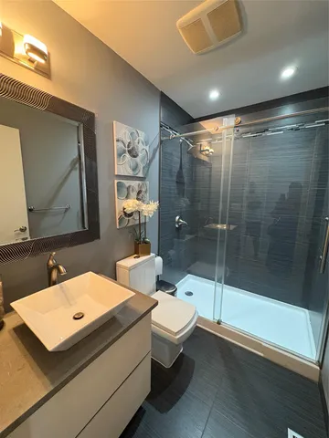 a bathroom with a sink toilet and shower