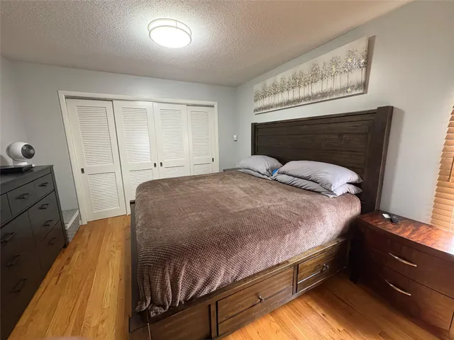 a bed sitting in a bedroom and chair
