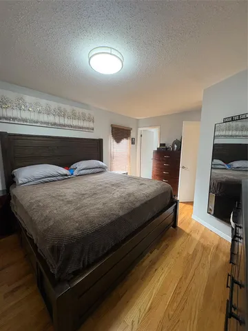 a bedroom with a bed and a television