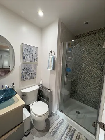 a bathroom with a toilet a sink and shower