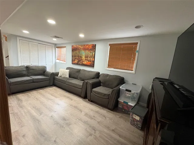 a living room with furniture window and a flat screen tv