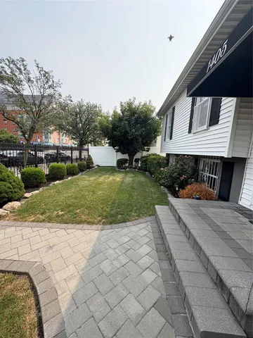 a front view of a house with a yard and trees