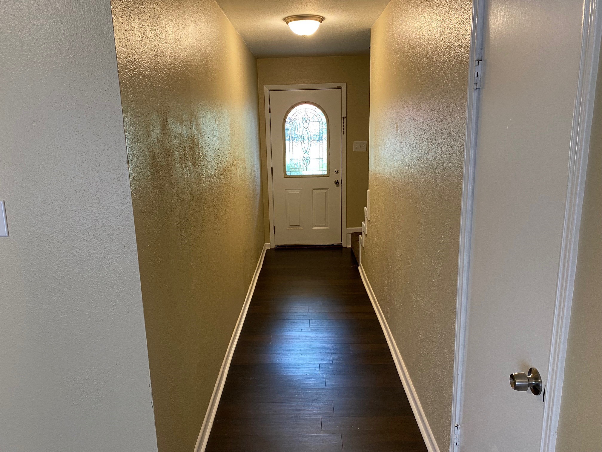 112 County Road 921 Angleton, TX 77515 - Photo 2 of 13 a view of a hallway with wooden floor and a mirror