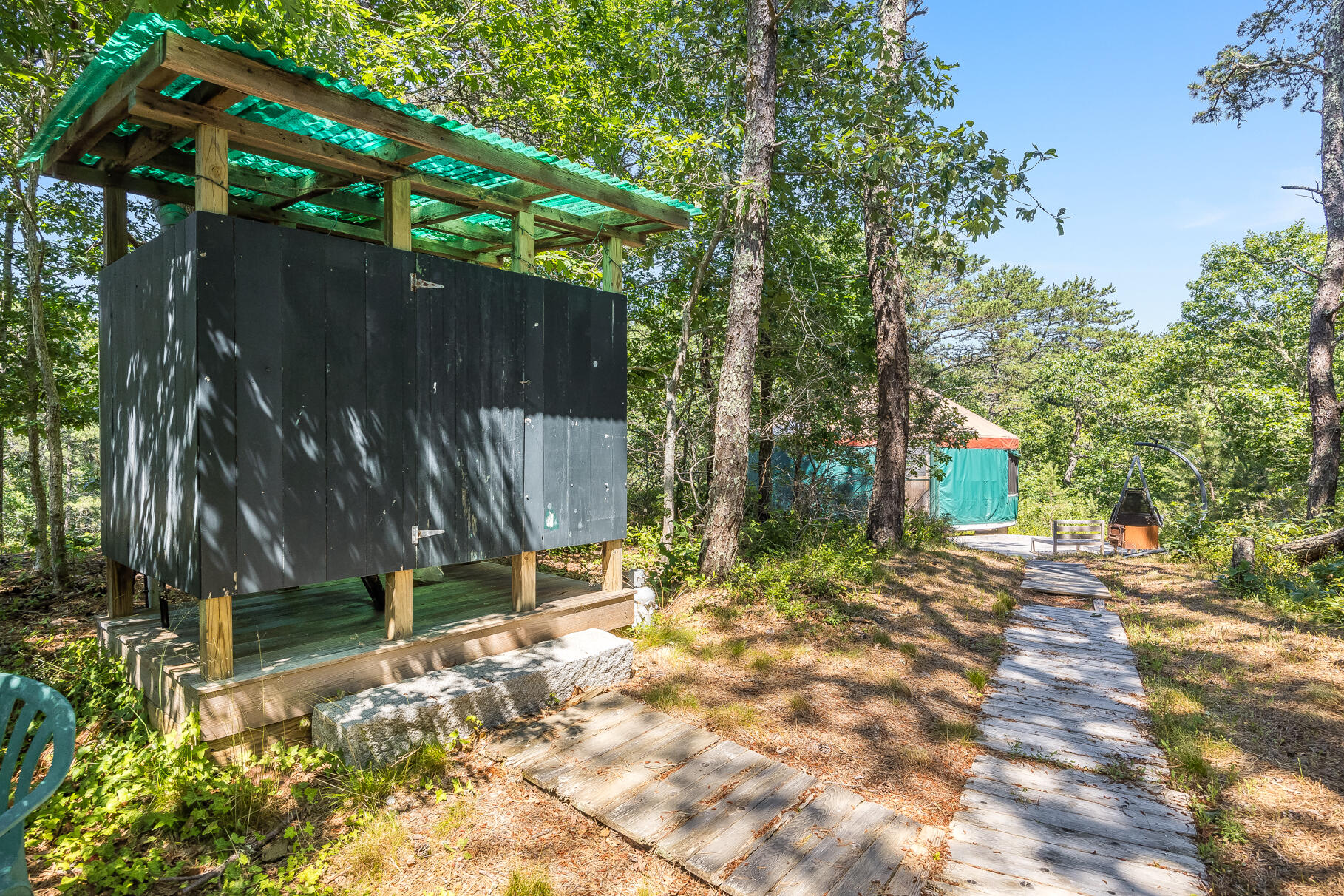 23 Old Bridge Road Truro, MA 02666 - Photo 22 of 44 a view of backyard with wooden fence and a large tree