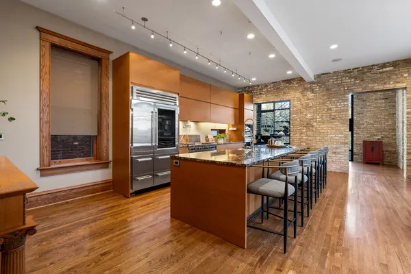 a large living room with stainless steel appliances granite countertop a couch and a view of living room