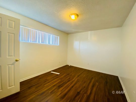 112 South Gold Canyon Street Ridgecrest, CA 93555 - Photo 7 of 8 a view of an empty room with wooden floor and closet