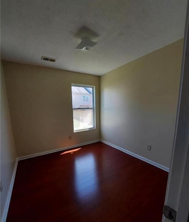 1749 Broad River Road Atlanta, GA 30349 - Photo 8 of 10 an empty room with wooden floor and windows