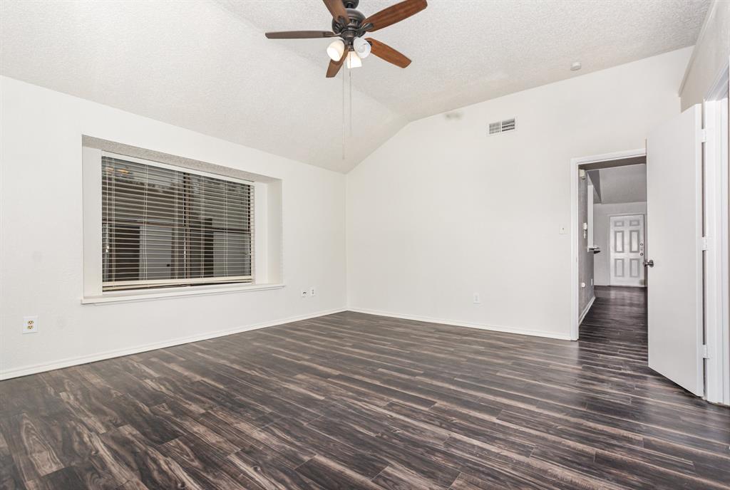 1046 Colony Street Flower Mound, TX 75028 - Photo 12 of 19 a view of an empty room with wooden floor and a window