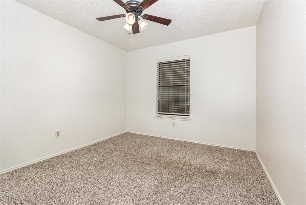 1046 Colony Street Flower Mound, TX 75028 - Photo 14 of 19 an empty room with a window and a fan