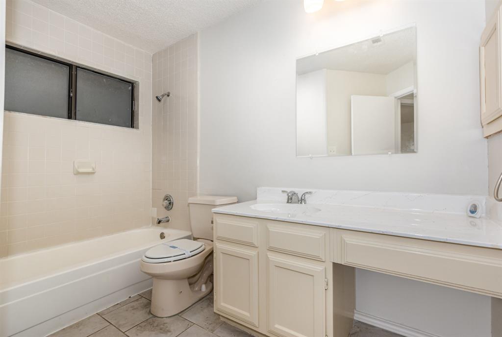 1046 Colony Street Flower Mound, TX 75028 - Photo 17 of 19 a bathroom with a sink toilet and shower
