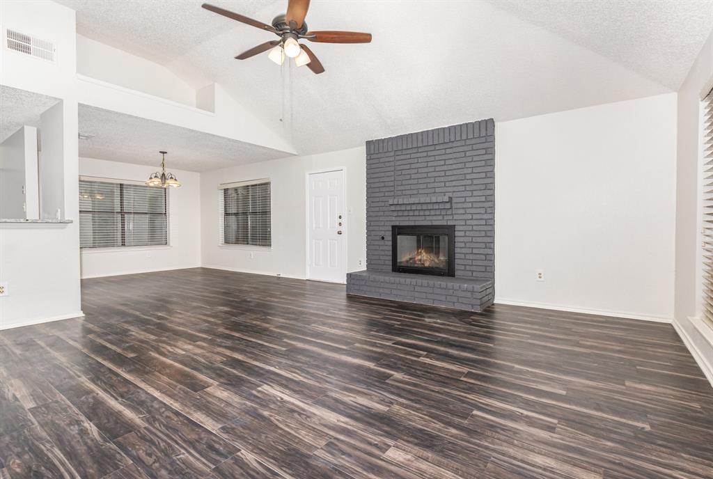 1046 Colony Street Flower Mound, TX 75028 - Photo 2 of 19 a view of a livingroom with wooden floor and a fireplace