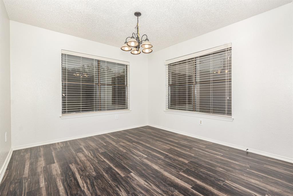 1046 Colony Street Flower Mound, TX 75028 - Photo 7 of 21 a view of an empty room with wooden floor and a window