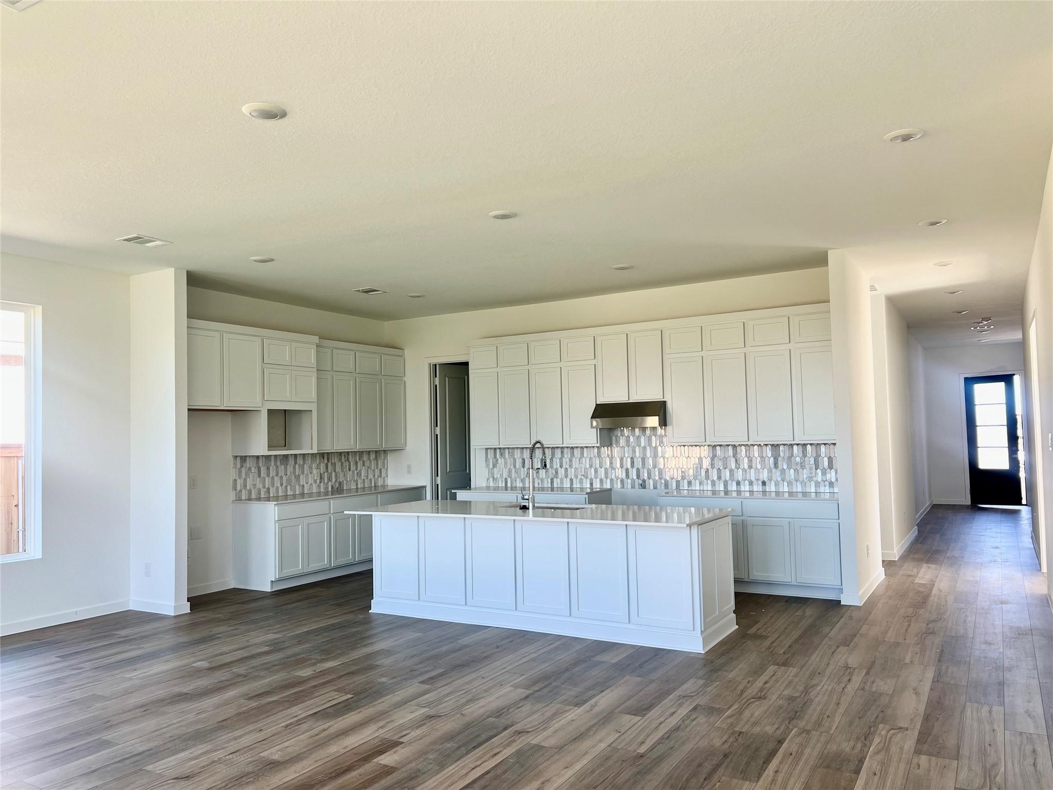 8326 Holly Blue Drive Rosharon, TX 77583 - Photo 16 of 29 a kitchen with stainless steel appliances a sink a stove a refrigerator and cabinets