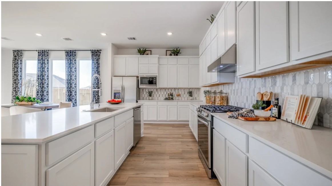 8326 Holly Blue Drive Rosharon, TX 77583 - Photo 23 of 29 a kitchen with kitchen island white cabinets and refrigerator