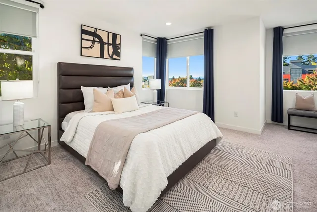 a large bed sitting in a bedroom next to a window
