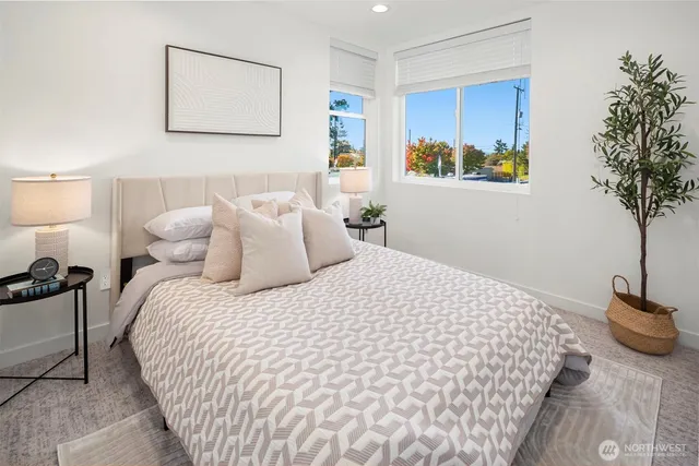a bedroom with bed and painting on the wall