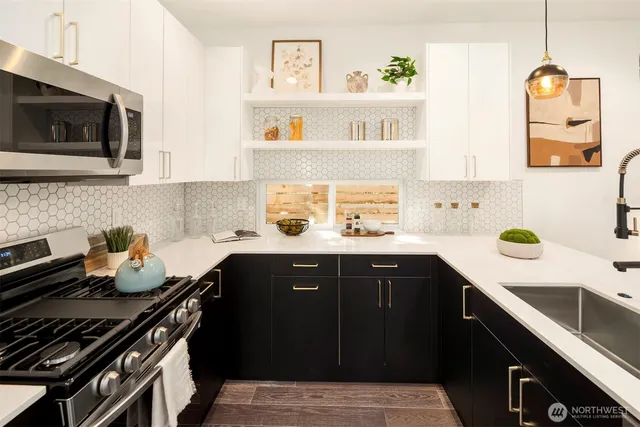 a kitchen with a sink stove and microwave