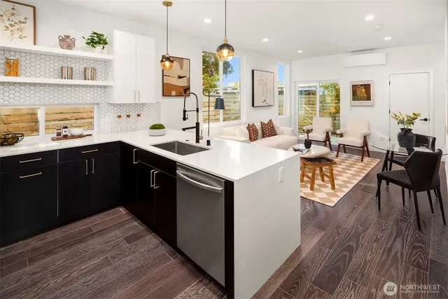 a kitchen with a sink stove and wooden floor