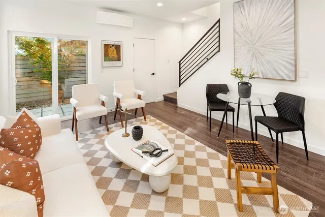 a living room with furniture and wooden floor