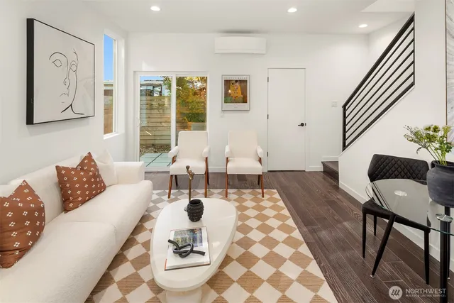 a living room with furniture and wooden floor