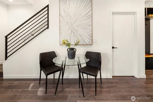 a view of a hallway with wooden floor and a potted plant