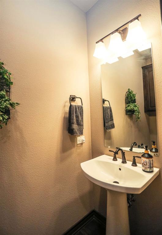 667 Comanche Lake Road Comanche, TX 76442 - Photo 14 of 26 a bathroom with a sink and mirror