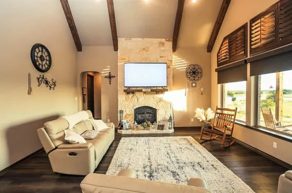 a bedroom with a bed and a large window