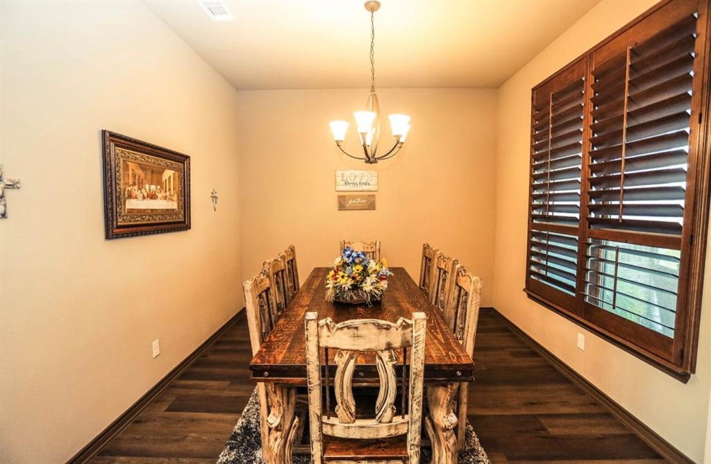 667 Comanche Lake Road Comanche, TX 76442 - Photo 20 of 26 a view of a dining room with furniture window and wooden floor