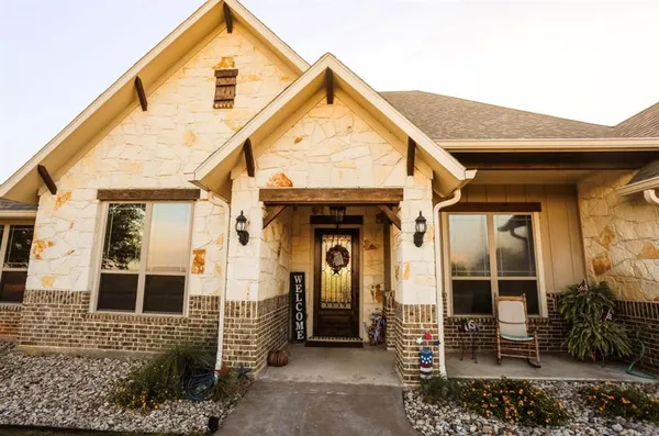 a view of a wooden house with large windows