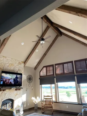 a bedroom with a bed and a ceiling fan