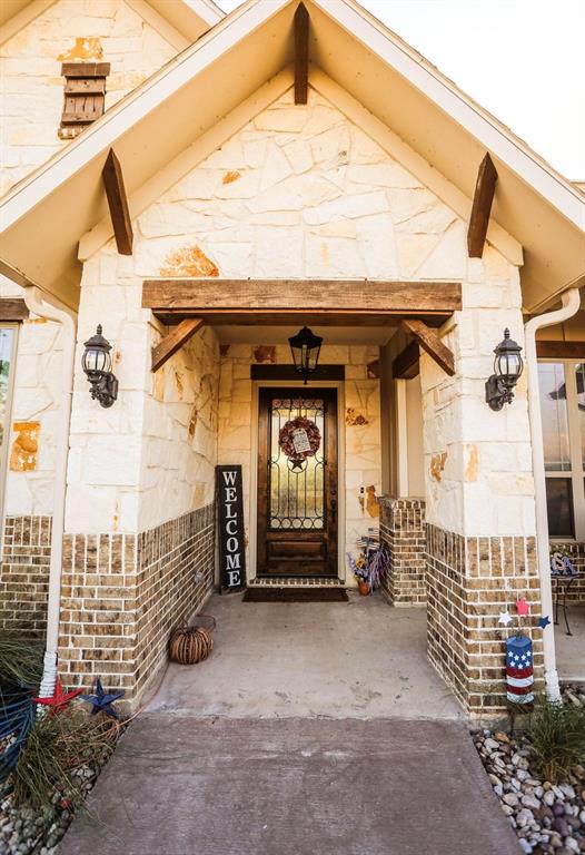 667 Comanche Lake Road Comanche, TX 76442 - Photo 3 of 26 a front view of a house with a garage
