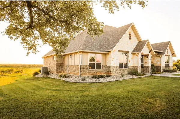 a big room with table and chairs under an umbrella
