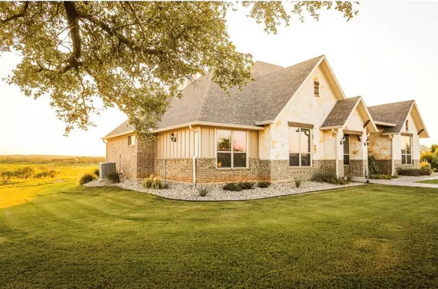 a big room with table and chairs under an umbrella