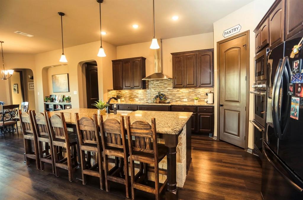 667 Comanche Lake Road Comanche, TX 76442 - Photo 7 of 26 a large kitchen with a table and chairs